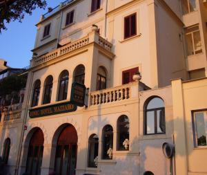 a building with a balcony on the side of it at Jonic Hotel Mazzarò in Taormina