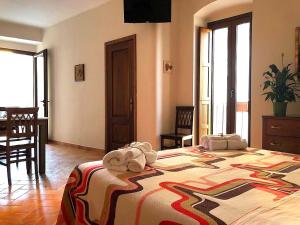 a bedroom with a bed with a stuffed animal on it at San Michele delle grotte BnB in Gravina in Puglia