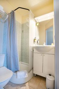 a bathroom with a sink and a toilet and a shower at Logis Hôtel Le Rialto in Le Sequestre