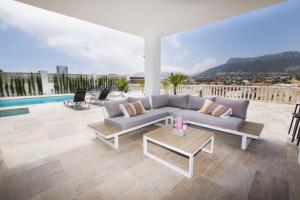 a living room with a couch and a table at Villas Guzman - Grandiosa in Calpe