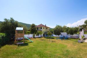 a yard with a playground and a house at Apartments Al Parma in Budva
