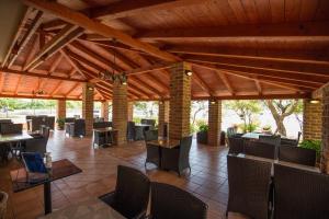 a dining area with tables and chairs in a restaurant at Villa Tamaris in Rab