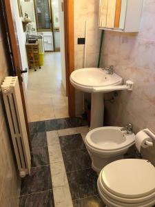 a bathroom with a toilet and a sink at Casa Christina in Galatone