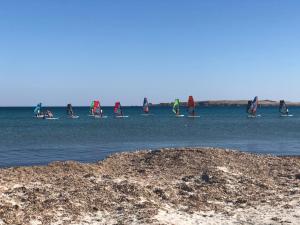 a group of people on paddle boards in the water at Thealassa in Kalliópi
