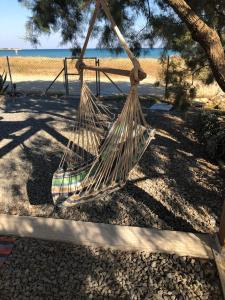 a hammock hanging from a tree on the beach at Thealassa in Kalliópi