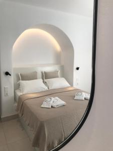 A bed or beds in a room at Quartano Luxury Cycladic Residence, Adults Only (13+)