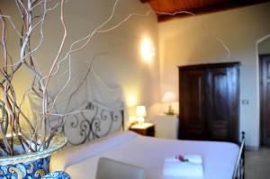 Letto o letti in una camera di Torre Don Virgilio Country Hotel