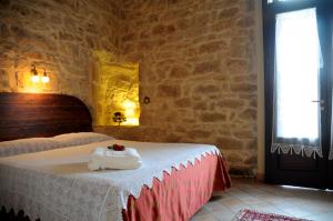 Letto o letti in una camera di Torre Don Virgilio Country Hotel