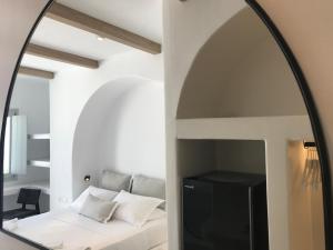 A bed or beds in a room at Quartano Luxury Cycladic Residence, Adults Only (13+)