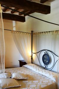 a bedroom with a large bed with a canopy at Grand Relais Laurenti in Gualdo Cattaneo