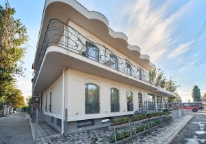 a building with a balcony on top of it at Gaudi stylish hotel in Odesa