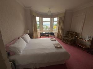 una camera d'albergo con un letto grande e una finestra di Dunrigh Guest House a Oban