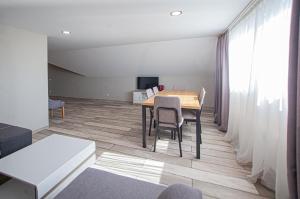 a living room with a table and chairs at Biplan Hotel in Daugavpils