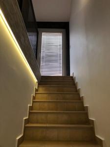 a staircase with a stair light and a window at Villa Santoma Hill in Koper