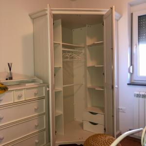 a wardrobe with glass doors next to a dresser at Villa Santoma Hill in Koper