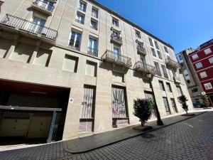 a large brick building with balconies on a street at CHURRUCA 3 in Vigo