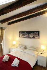 twee bedden in een slaapkamer met twee witte handdoeken bij San Teodoro Apartment in Rome