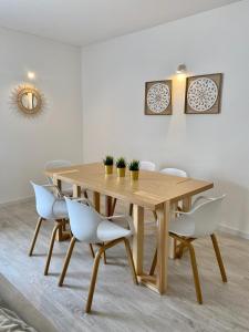 een houten tafel en stoelen in een kamer bij White Sand Apartments Downtown Albufeira in Albufeira