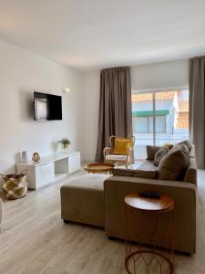 a living room with a couch and a table at White Sand Apartments Downtown Albufeira in Albufeira