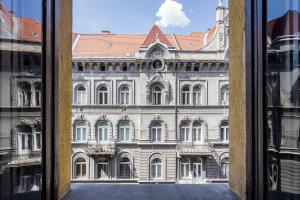 a view of a large building from a window at K33- Quality Apartments, Best Location, by BQA in Budapest