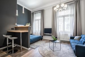 a living room with a blue couch and a table at K33- Quality Apartments, Best Location, by BQA in Budapest +121 photos