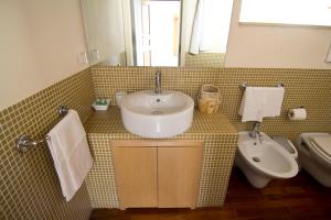 a bathroom with a sink and a toilet at La Via della Giudecca in Syracuse
