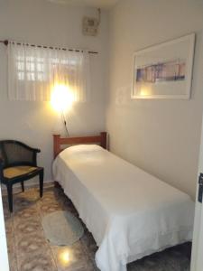 A bed or beds in a room at Casa da Lili-ESPAÇO INDEPENDENTE E PRIVATIVO