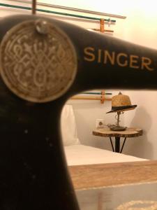 a sewing machine with the word singer on a table at Naiades Residence in Pigi