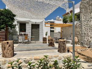 a backyard with a patio with trees and a building at Naiades Residence in Pigi