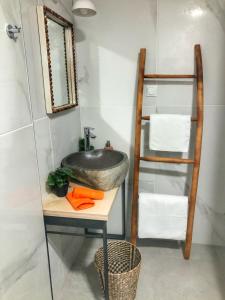 a bathroom with a sink and a ladder and towels at Naiades Residence in Pigi +64 photos