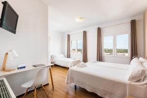 Postel nebo postele na pokoji v ubytování Hostal Jume - Urban Rooms