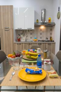 a kitchen with a glass table with fruit on it at Vintage Home in Catanzaro Lido