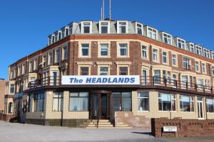 a red brick building with a sign for the headlands at The Headlands in Blackpool