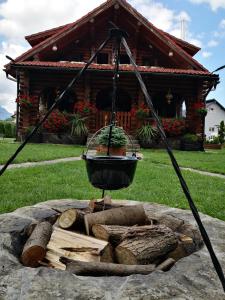 a fire pit in front of a log cabin at Cabana Rustic Bran in Bran