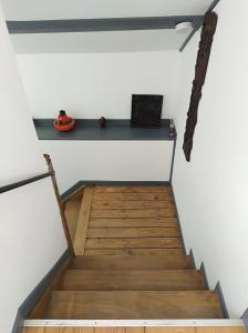 a stairway with a blue shelf on a white wall at Un studio à louer ds un endroit calme près de la ville de Dinant in Dinant