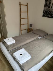 two beds in a room with towels on them at Great B&B at Amstelbeach in Amsterdam +2 photos
