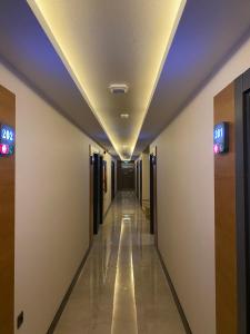 a hallway in a building with signs on the ceilings at MİYAS LUXURY HOTEL in Kemer