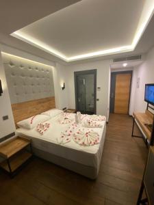 a bedroom with a large bed with flowers on it at MİYAS LUXURY HOTEL in Kemer