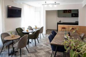 a dining room with two tables and chairs at Duett - Urban Rooms in Győr