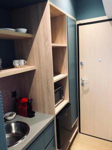 a small kitchen with a sink and a door at Metropolitan Complex budget room@Faliro in Piraeus