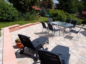 a patio with a table and chairs on a brick patio at Penzion Cabák in Vrchlabí