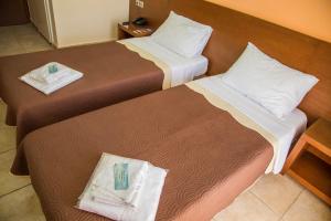 Un pat sau paturi într-o cameră la Hotel Giorgio +52 fotografii