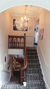 a staircase in a home with a chandelier at Tynedale Guest House in Penrith