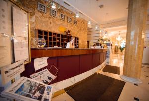 a bar in a restaurant with a woman behind the counter at Ambassador in Saint Petersburg