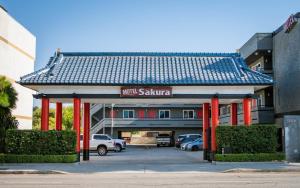 a parking lot with a building with a sauna at Motel Sakura in Glendale