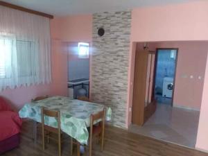 a room with a table and a living room with a couch at Denis Bolanča in Primošten