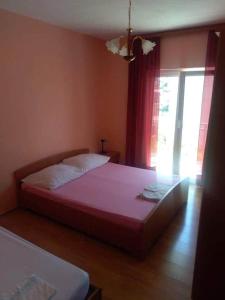 a bedroom with a bed and a window at Denis Bolanča in Primošten