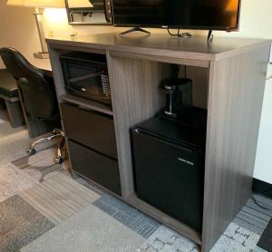 a desk with a tv and a computer in a room at Super 8 by Wyndham Spokane Valley in Spokane Valley