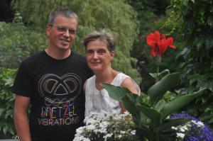 a man and a woman standing in a garden at Bertricher Hof in Bad Bertrich