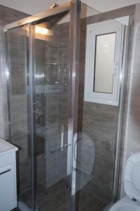 a glass shower in a bathroom with a toilet at Di fronte alla fortezza in Nafplio